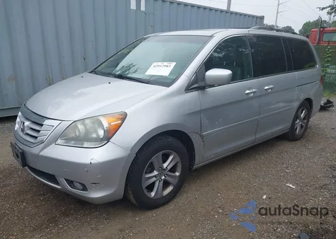 2010 Honda Odyssey Touring z USA, uszkodzony, nr VIN 5FNRL3H9XAB085936